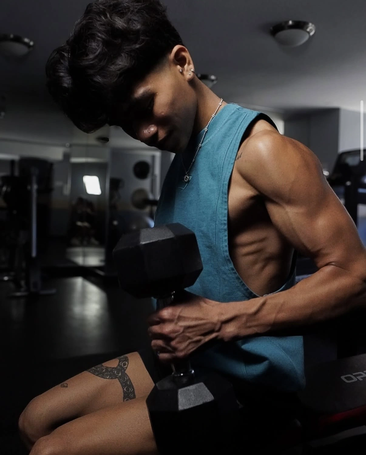 Man lifting a dumbbell during a gym portrait session
